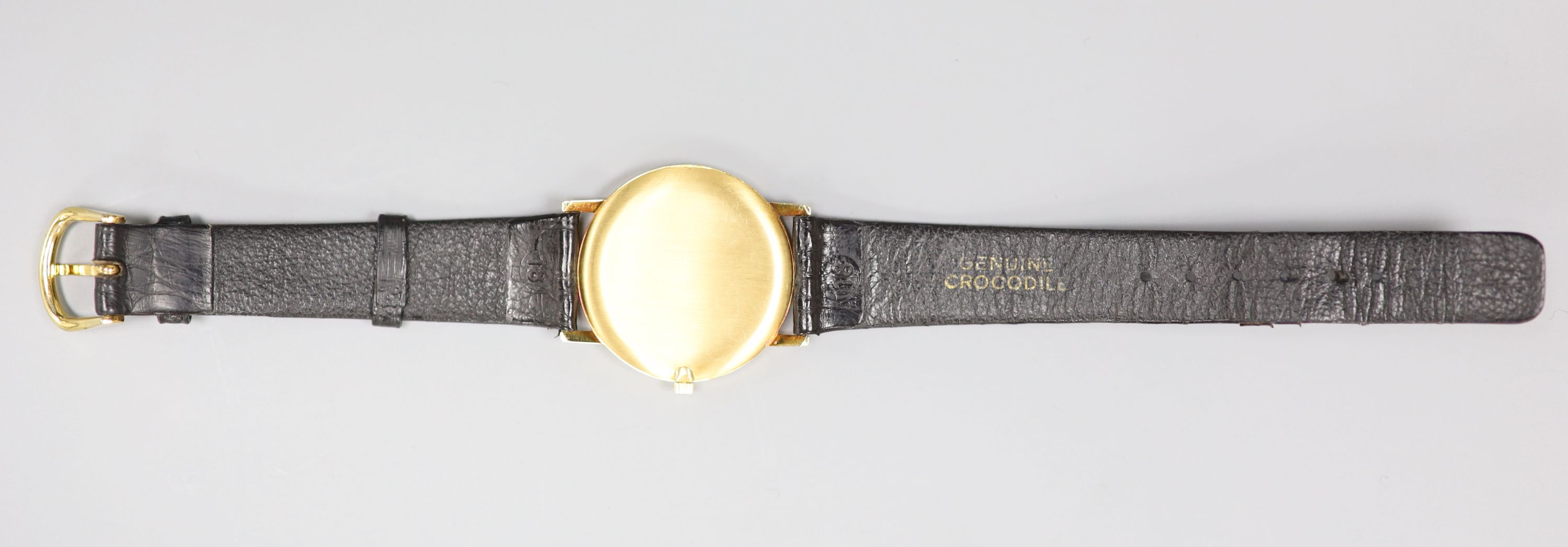 A gentlemans modern 18ct gold quartz dress wrist watch, retailed by Garrard, on a black leather strap, with Garrard box,